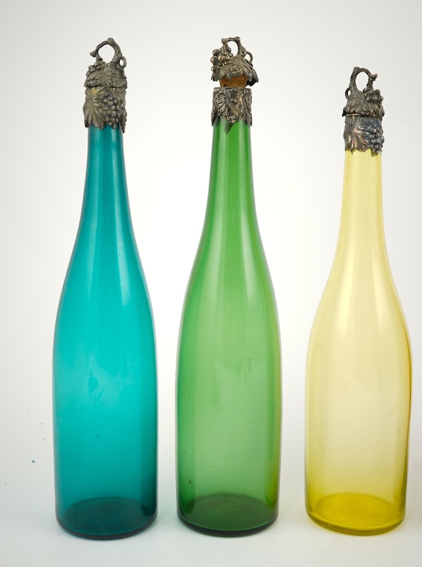 A composed set of six mid 19th century vari-coloured glass carafes